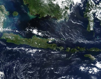 True-color satellite image of Indonesia mid-May 2002. As burning season was not fully underway in the region, skies over the island of Borneo, Malaysia at its northwest coast, are comparatively clear by National Aeronautics and Space Administration National Aeronautics and Space Administration